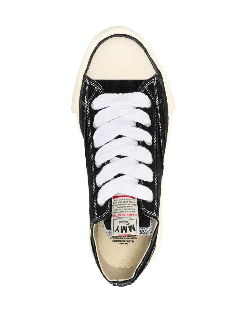 Black lace-up sneakers with white laces, inner tongue label patch, cream sole