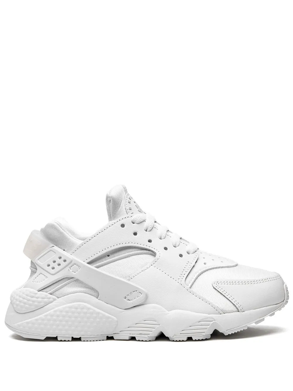 White Nike Air Huarache lace-up sneakers with cushioned sole and side logo
