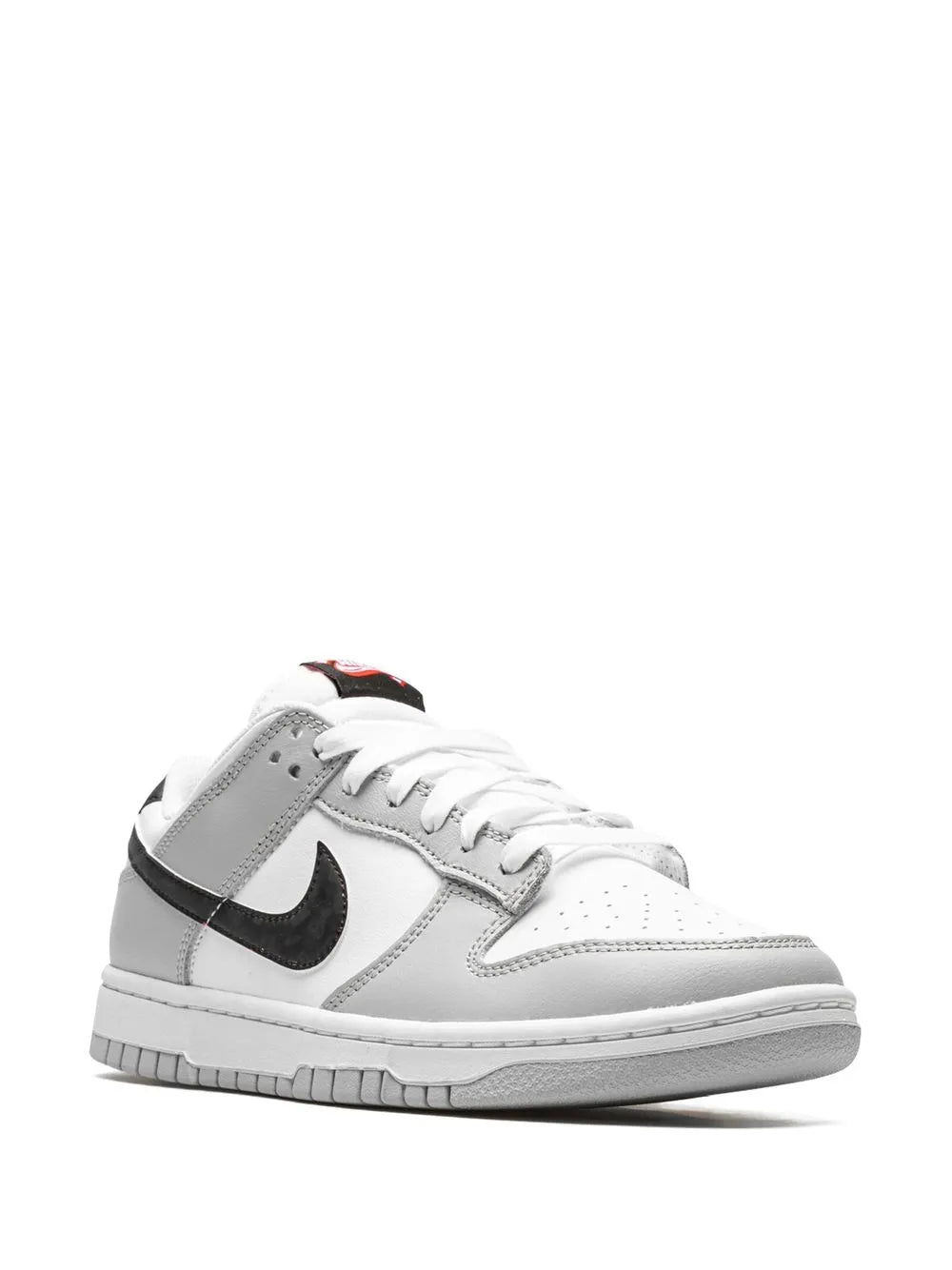 White low-top sneaker with black Swoosh and gray overlays, lace-up.