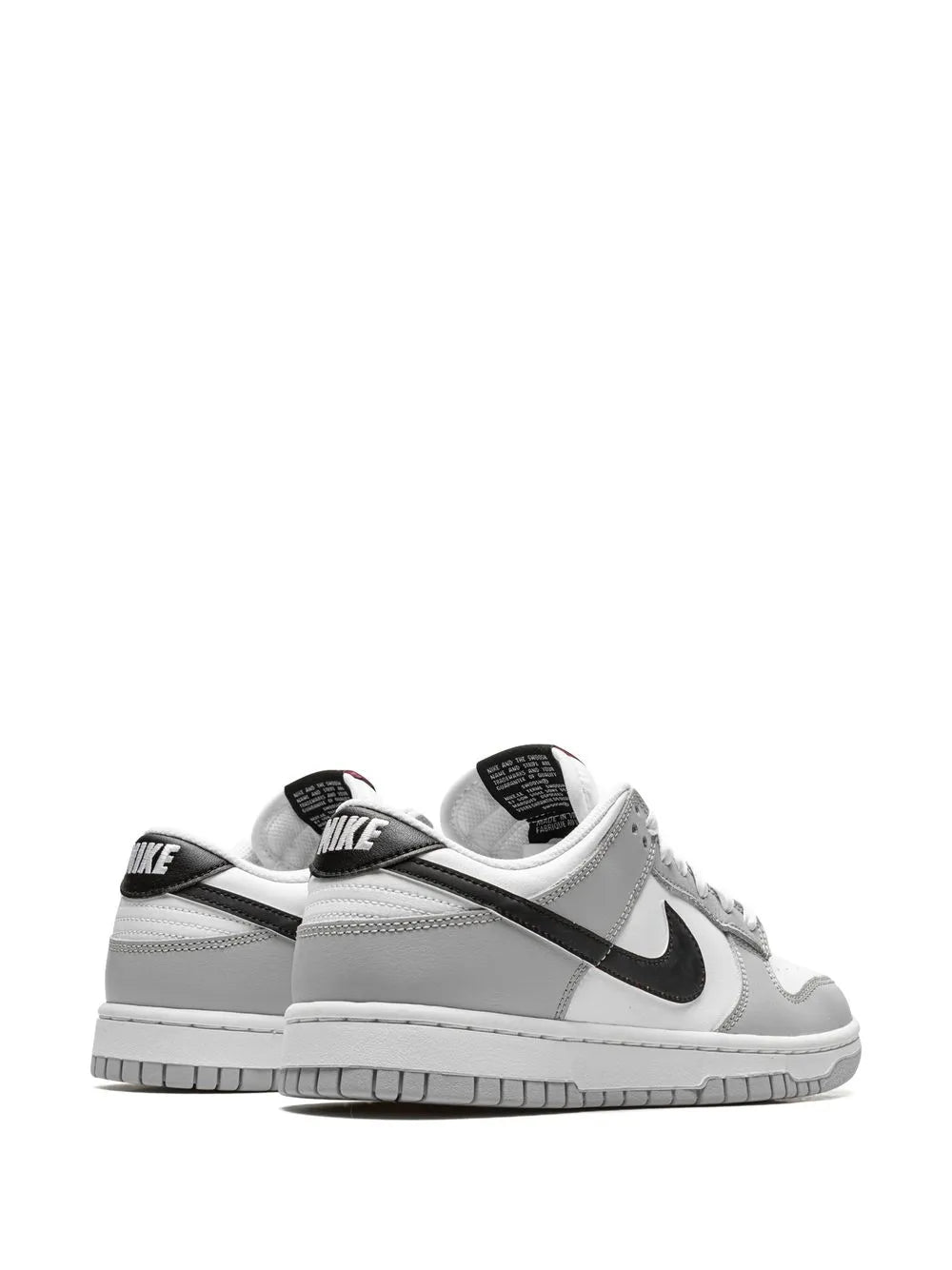 Back view of white low-top sneaker with black Swoosh and Nike heel tab.