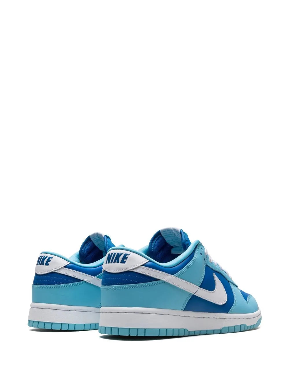 Pair of light blue low-top sneakers with white swoosh and navy heel