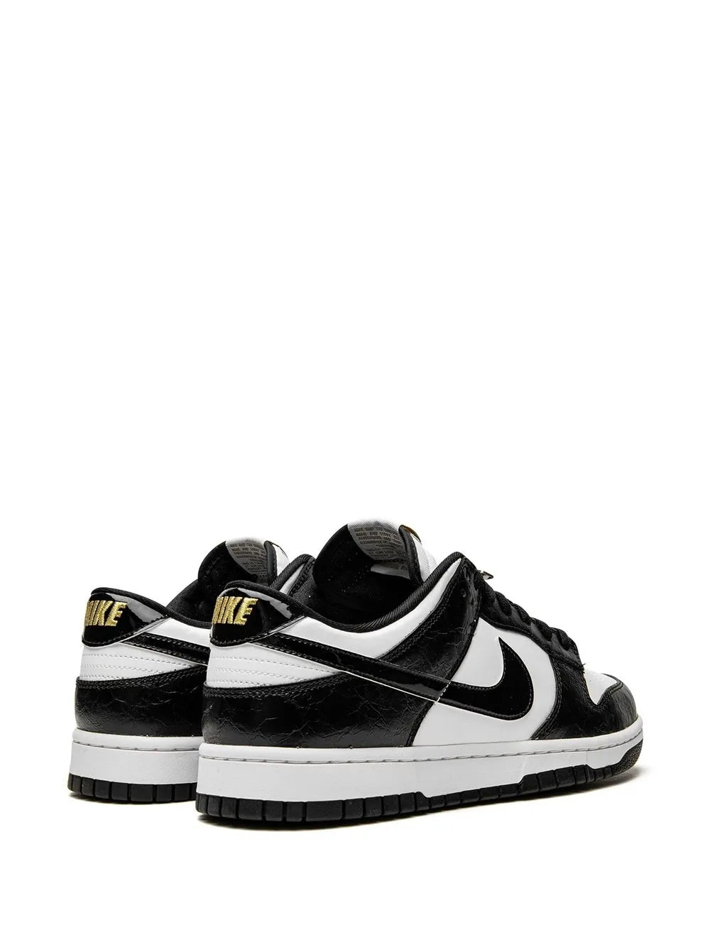Black and white low-top sneaker pair view, heel tab, Nike swoosh, lace-up
