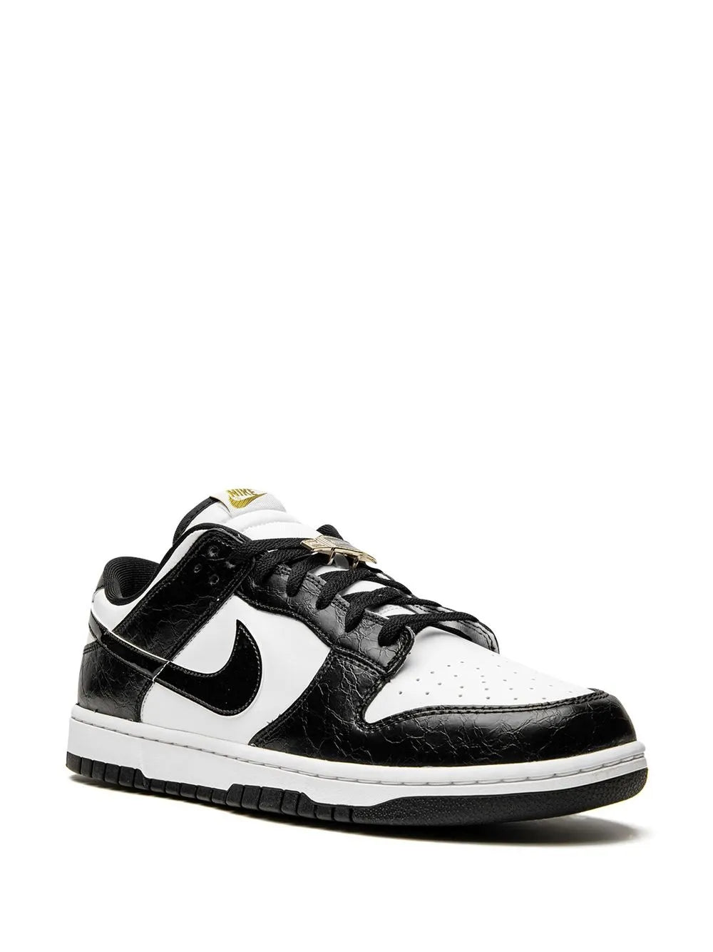Black and white low-top sneaker with swoosh, perforated toe panel, lace-up