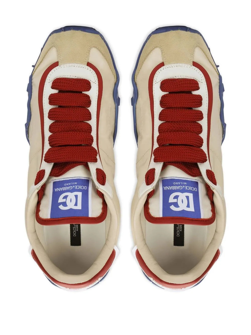Low-top sneakers pair, cream uppers with red laces and blue heel details.