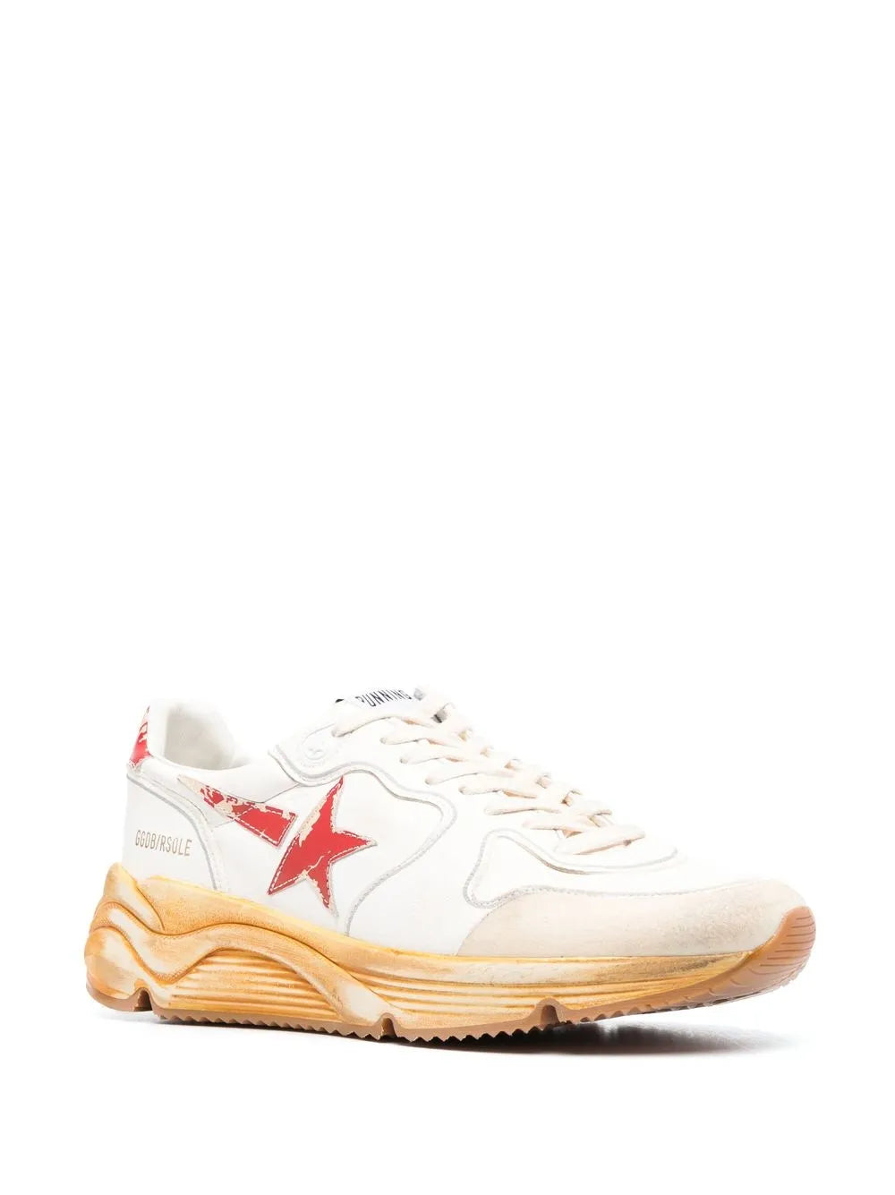 White low-top sneakers with red side star detail and tan chunky sole