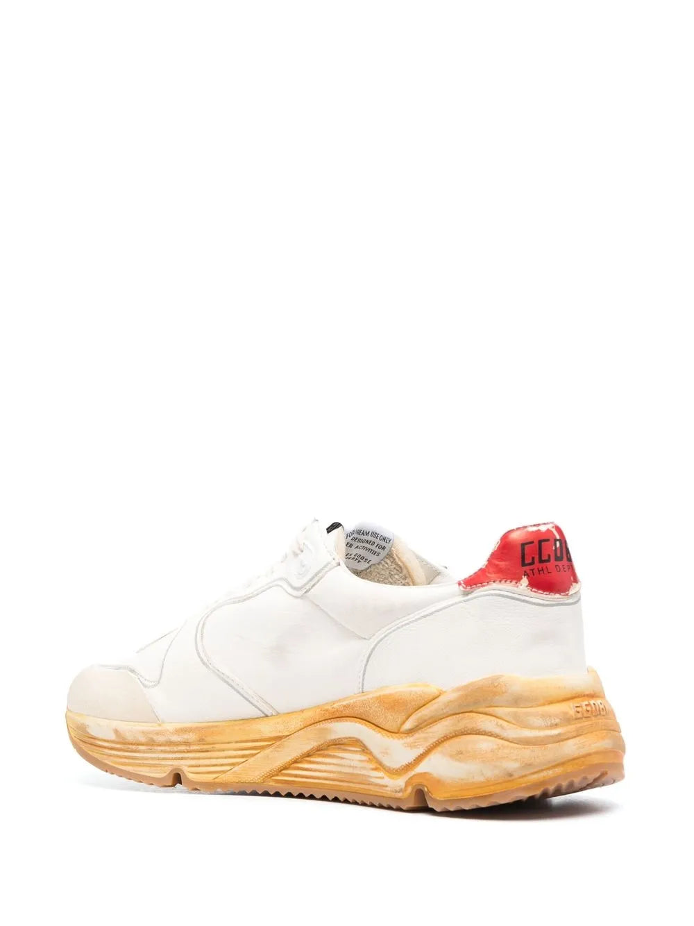 White low-top sneakers with red heel detail and tan chunky sole