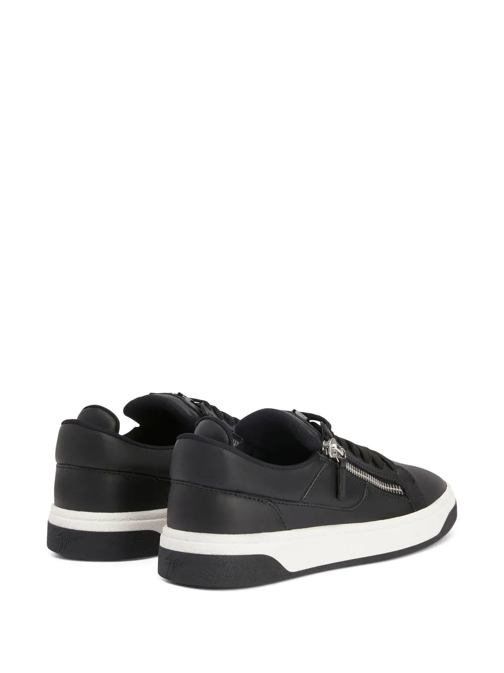 Black low-top sneakers with dual zippers and white sidewall sole trim