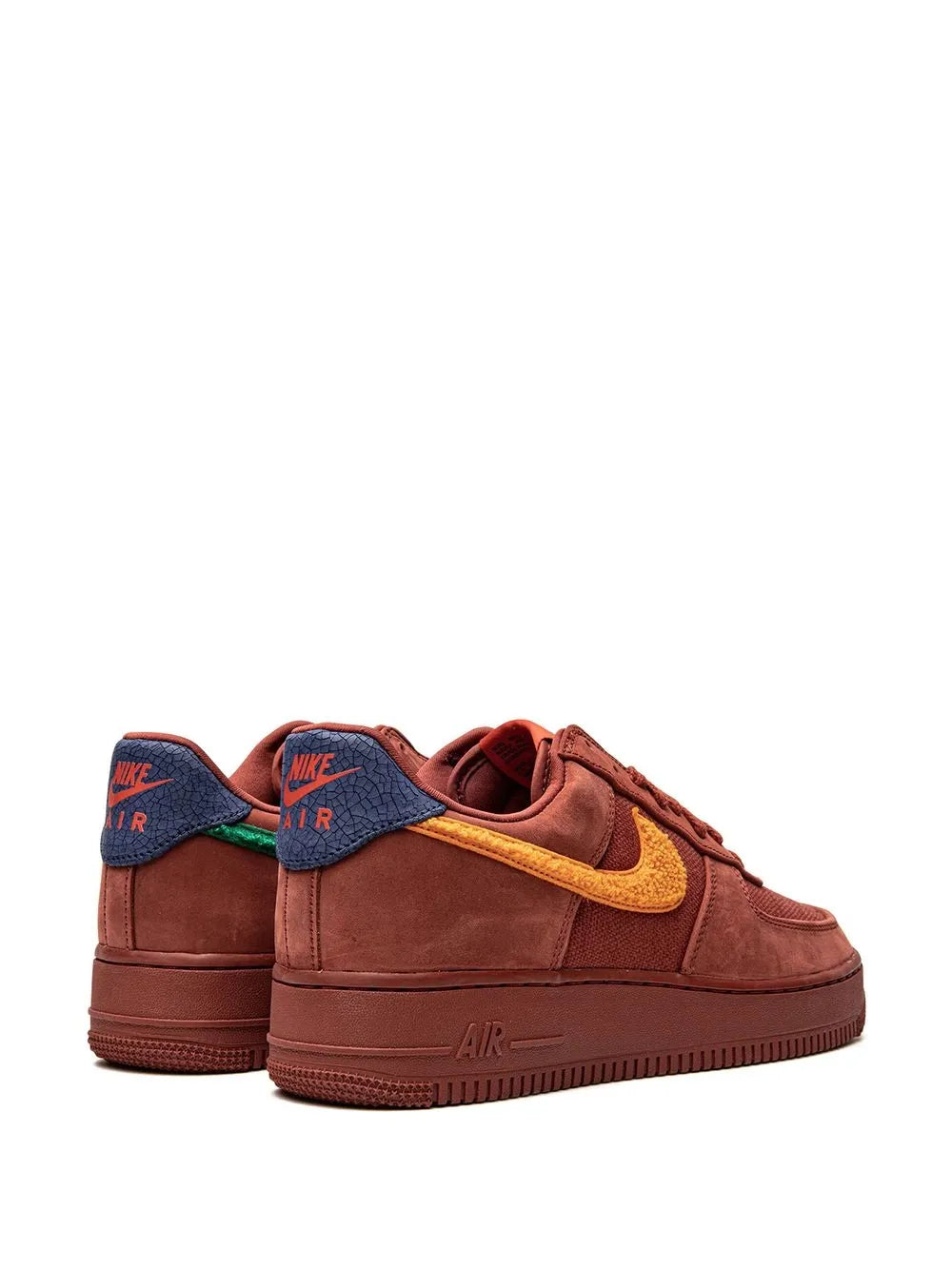 Red suede low-top sneakers, pair view, with yellow swoosh and blue rear panels