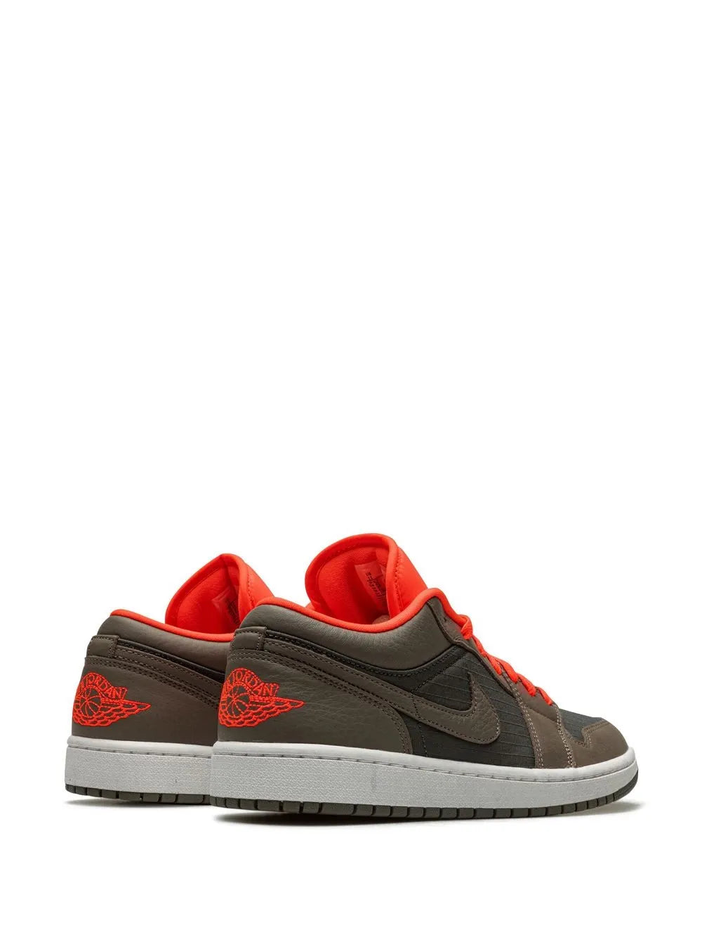 Low-top sneakers with orange collar lining, dark gray back panel, and orange lace tips