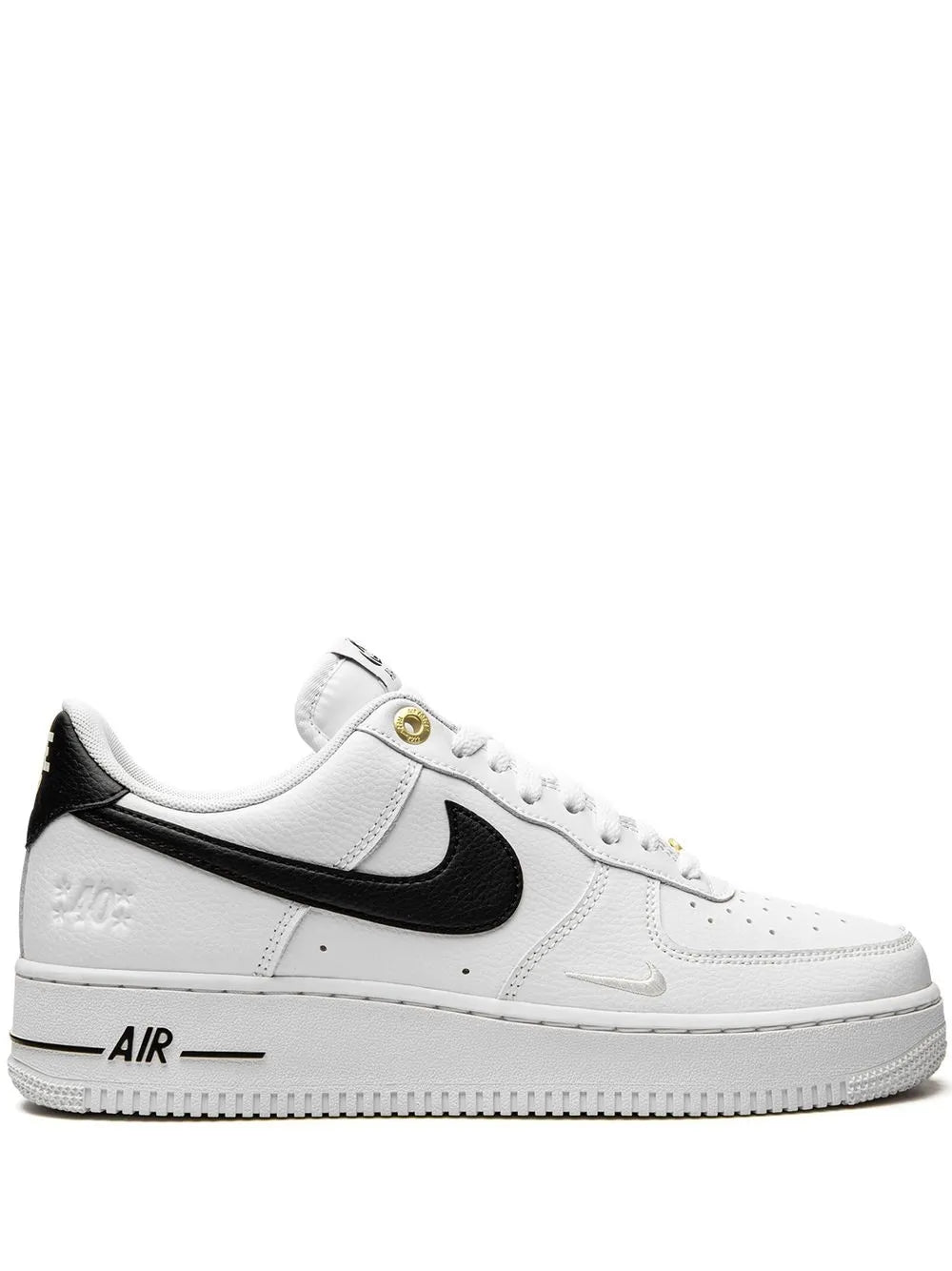 Nike Air Force 1 low-top sneakers: white leather, black swoosh, gold eyelets