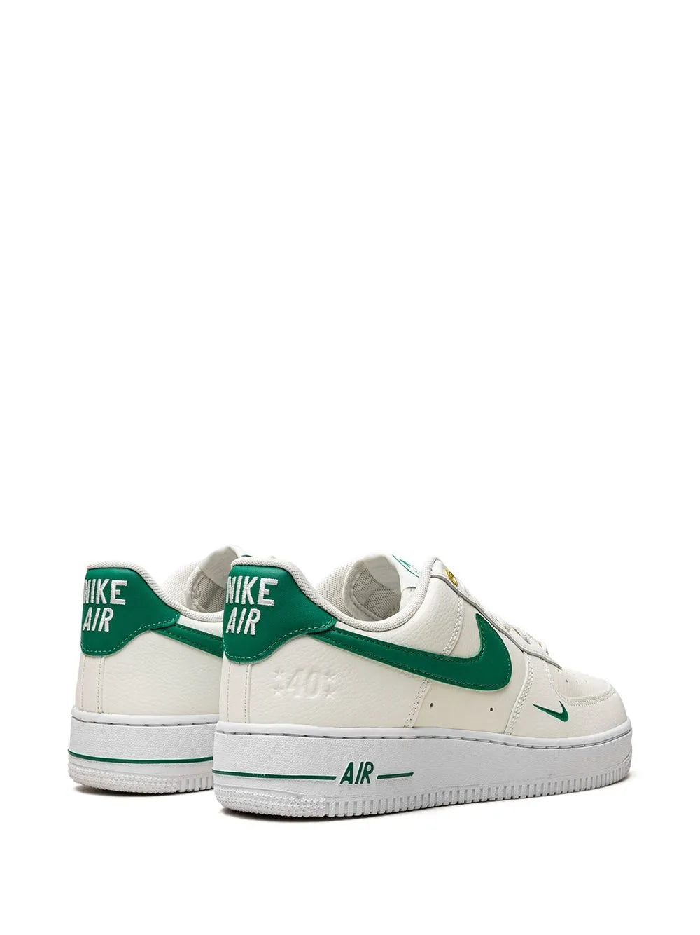 Nike low-top sneakers with white uppers, green heel tabs, and 'AIR' branding