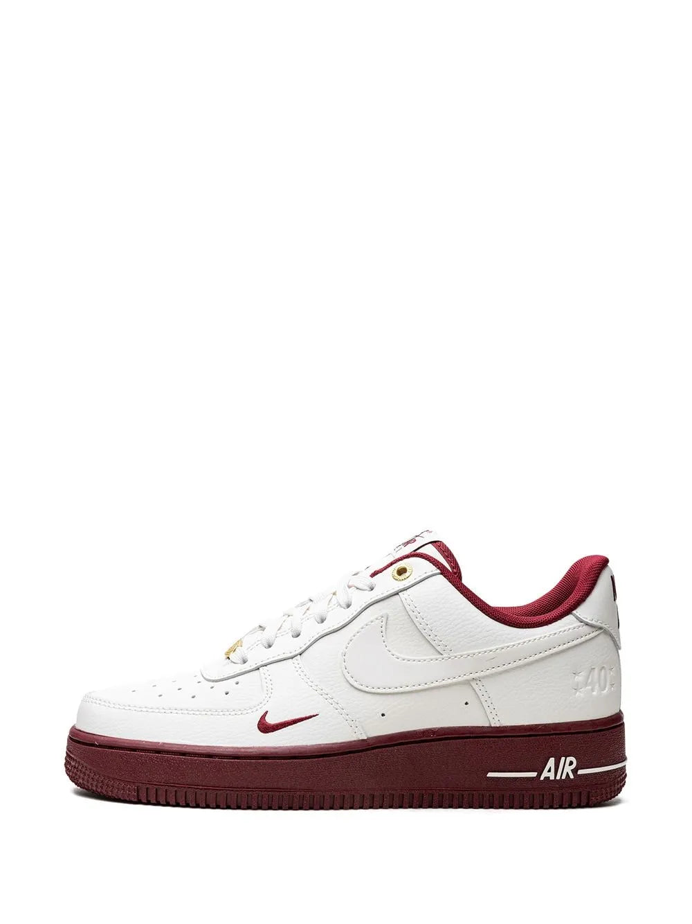 White Nike low-top sneaker with burgundy swoosh and heel Air logo