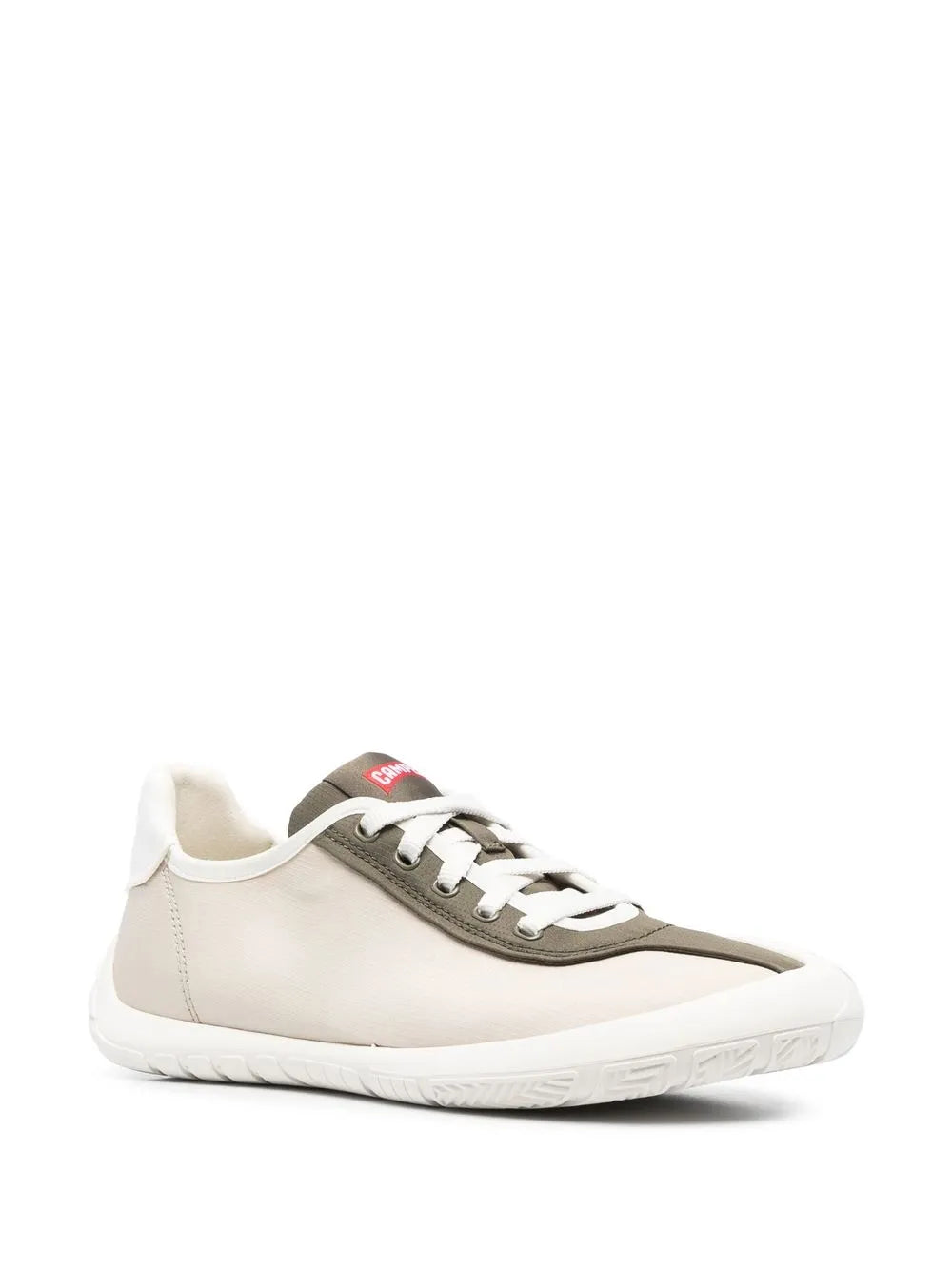 Low-top sneakers, side view: white upper with dark gray trim, white laces, thick white sole.