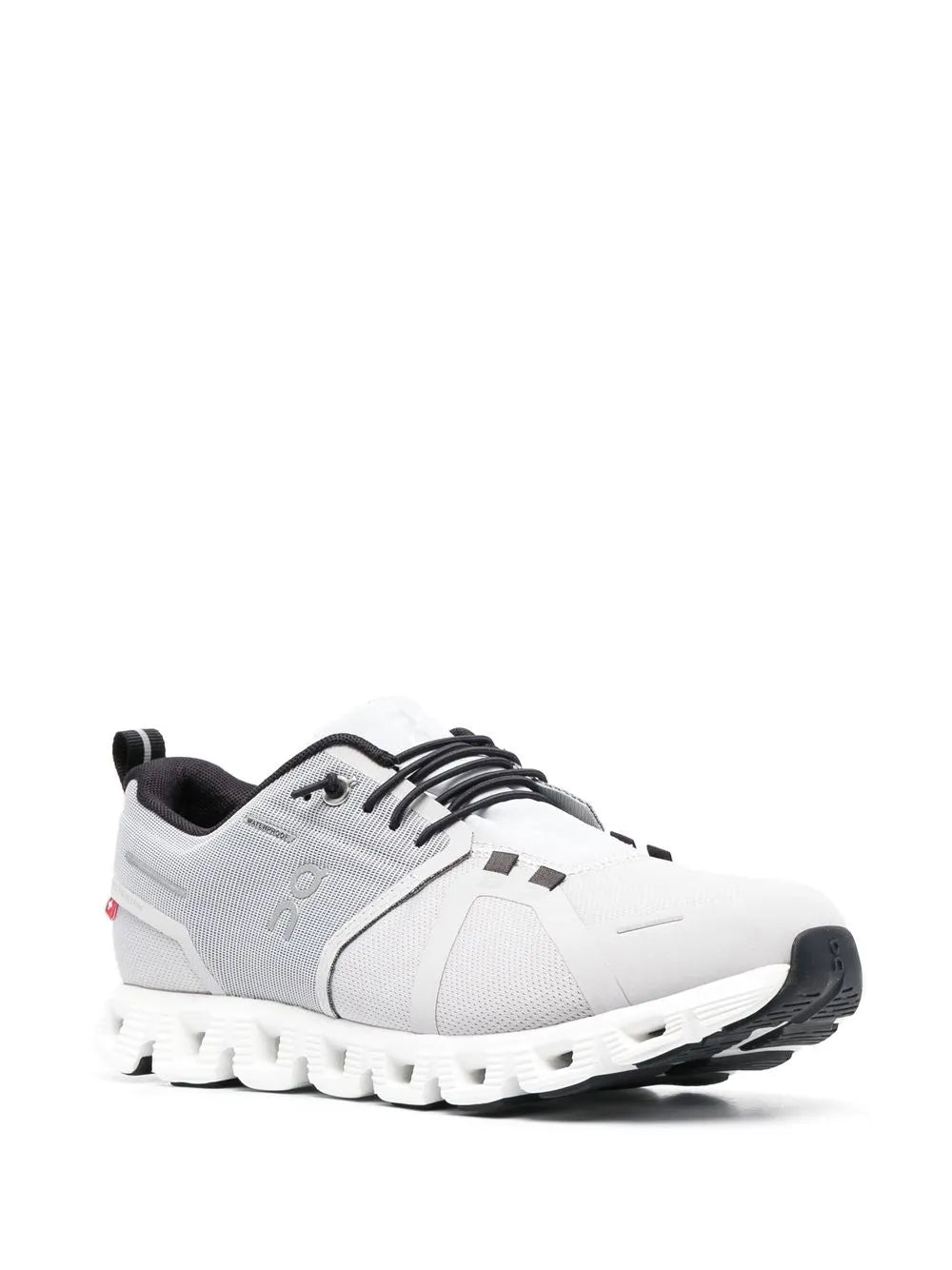 White low-top running shoes with gray side panel, black heel trim, and cushioned sole pods