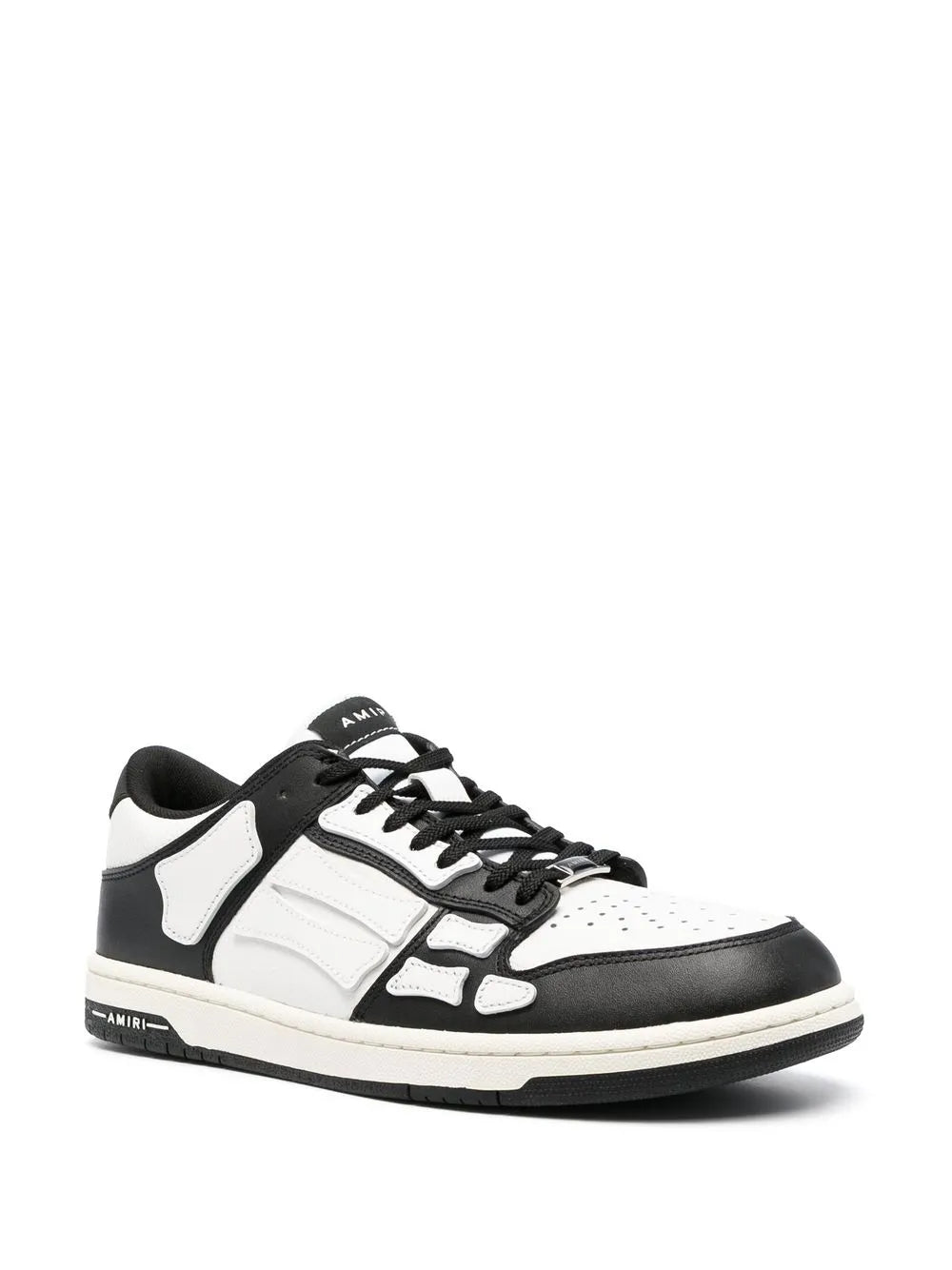 White and black low-top lace sneakers with skeletal side detail and black heel tab