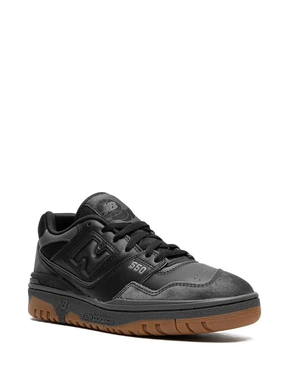 Black New Balance 550 sneakers with 550 logo, gum outsole, and lace-up design