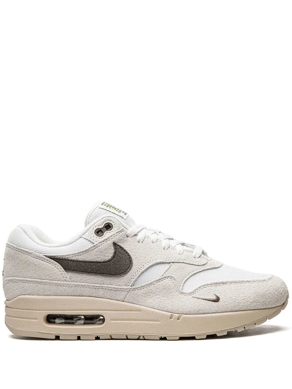 Off-white low-top sneaker with dark gray swoosh and visible Air unit