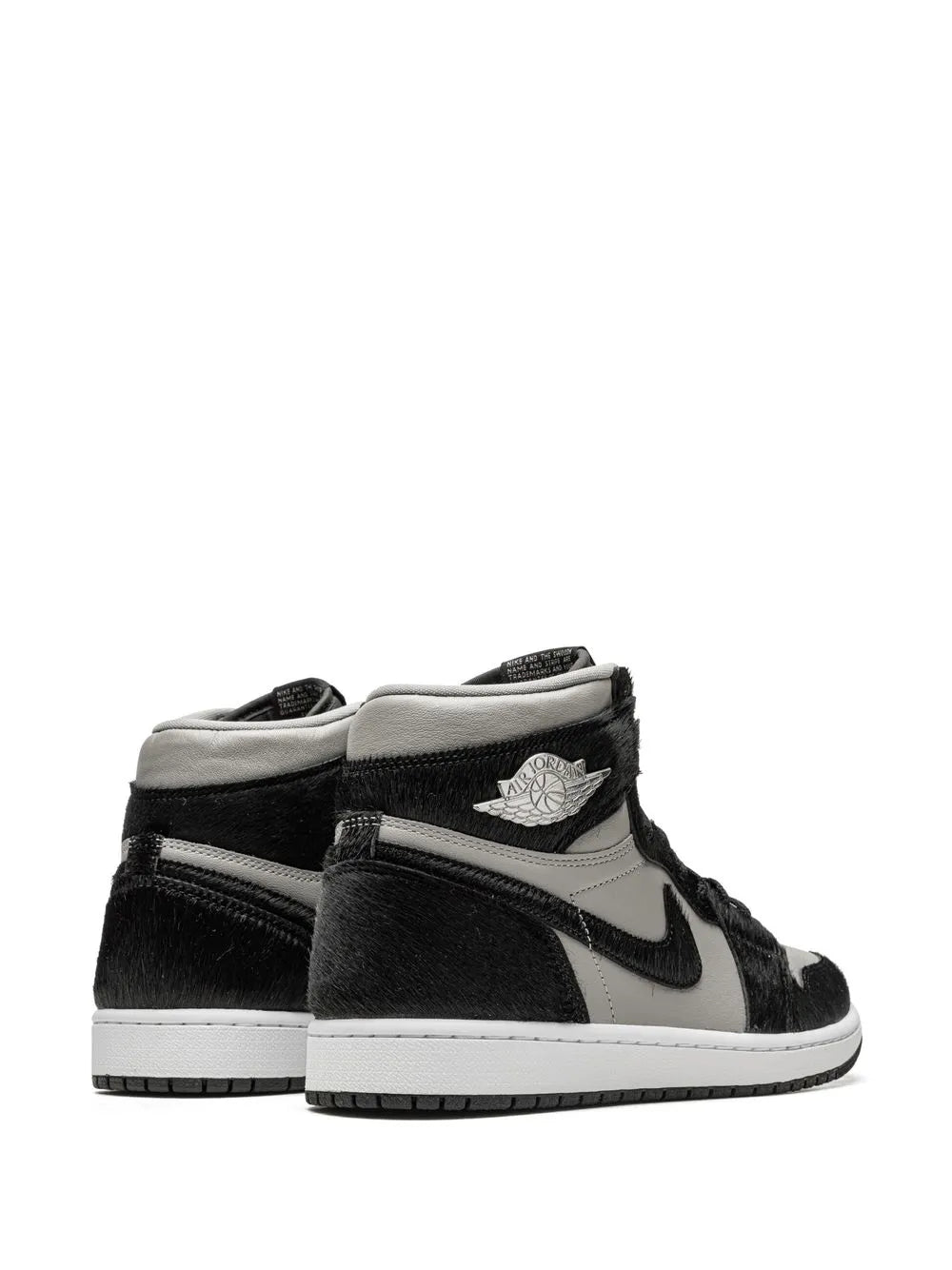 Black and white Air Jordan 1 high-top sneaker, heel and collar with Wings logo