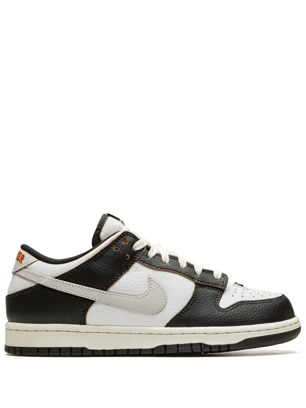 Black and white low-top Nike sneakers with white Swoosh, lace-up front