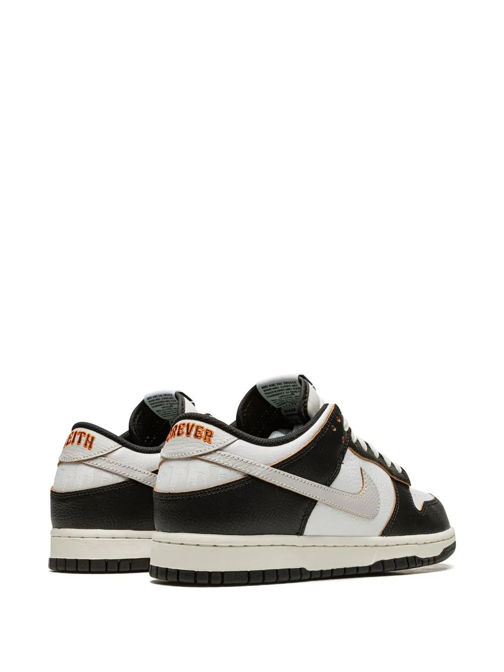 Black and white Nike low-top sneakers, rear side view with padded collar