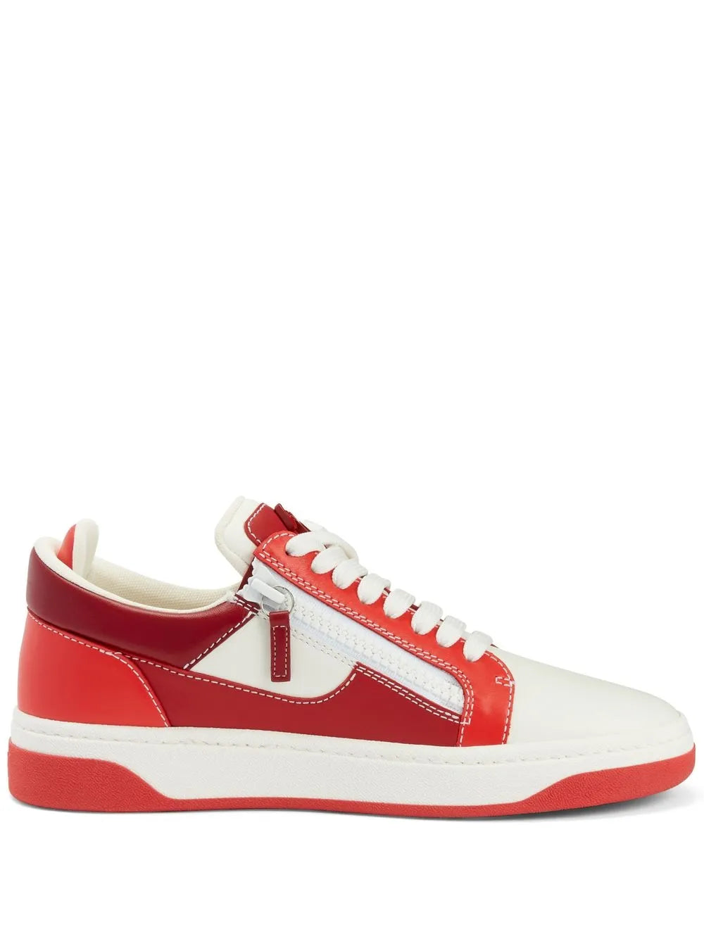 Red and white low-top double-zip sneakers with white laces and side zipper tabs