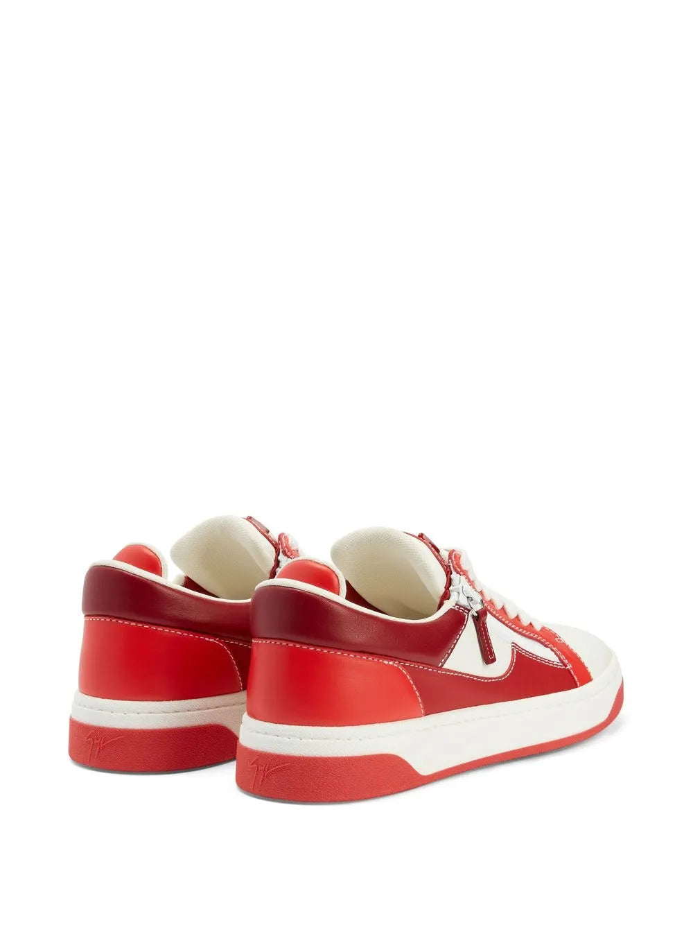 Rear view red and white low-top sneakers with heel tabs and zipper detail