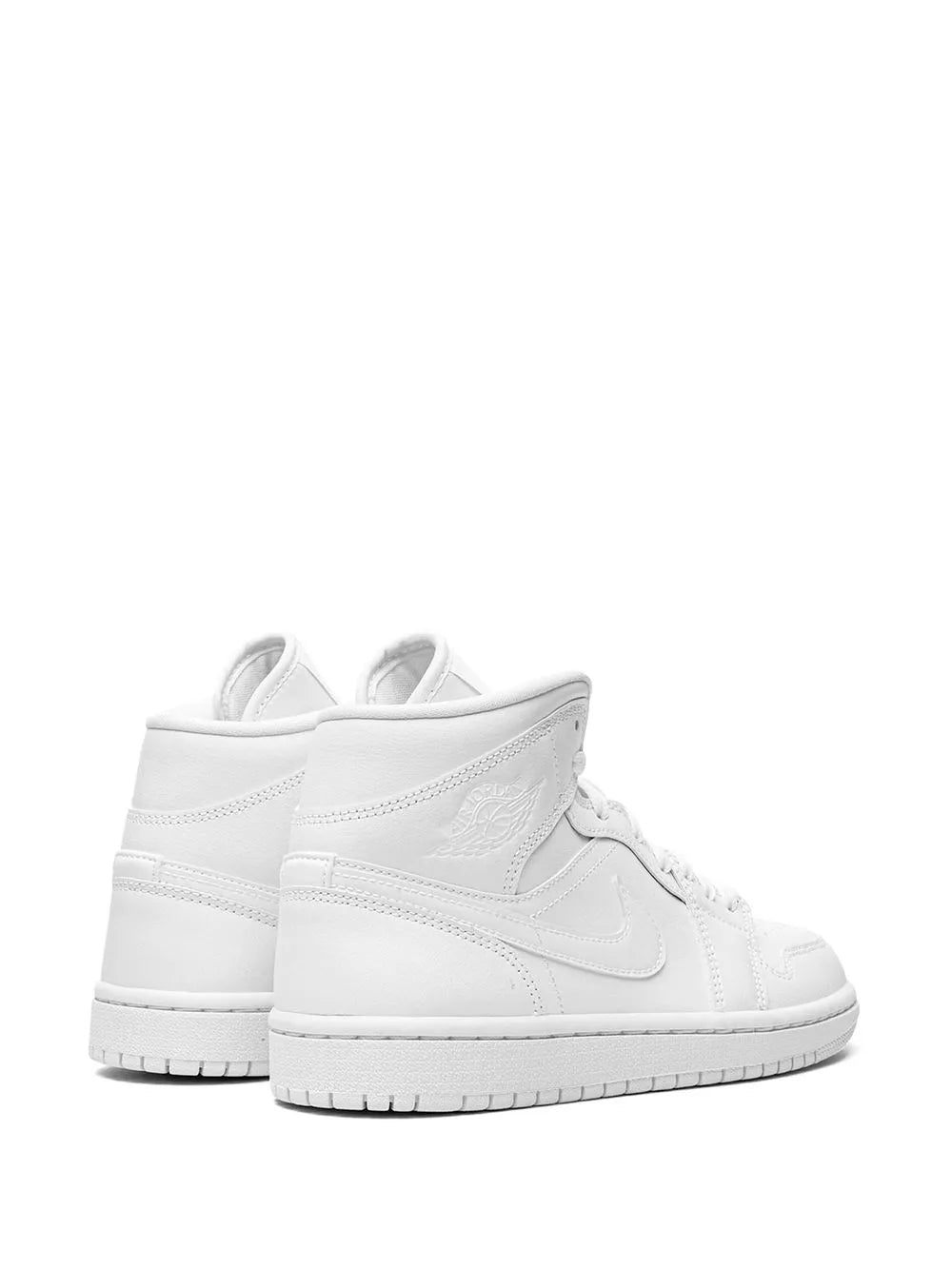 White mid-top sneakers pair view, padded collar and lace-up front with swoosh