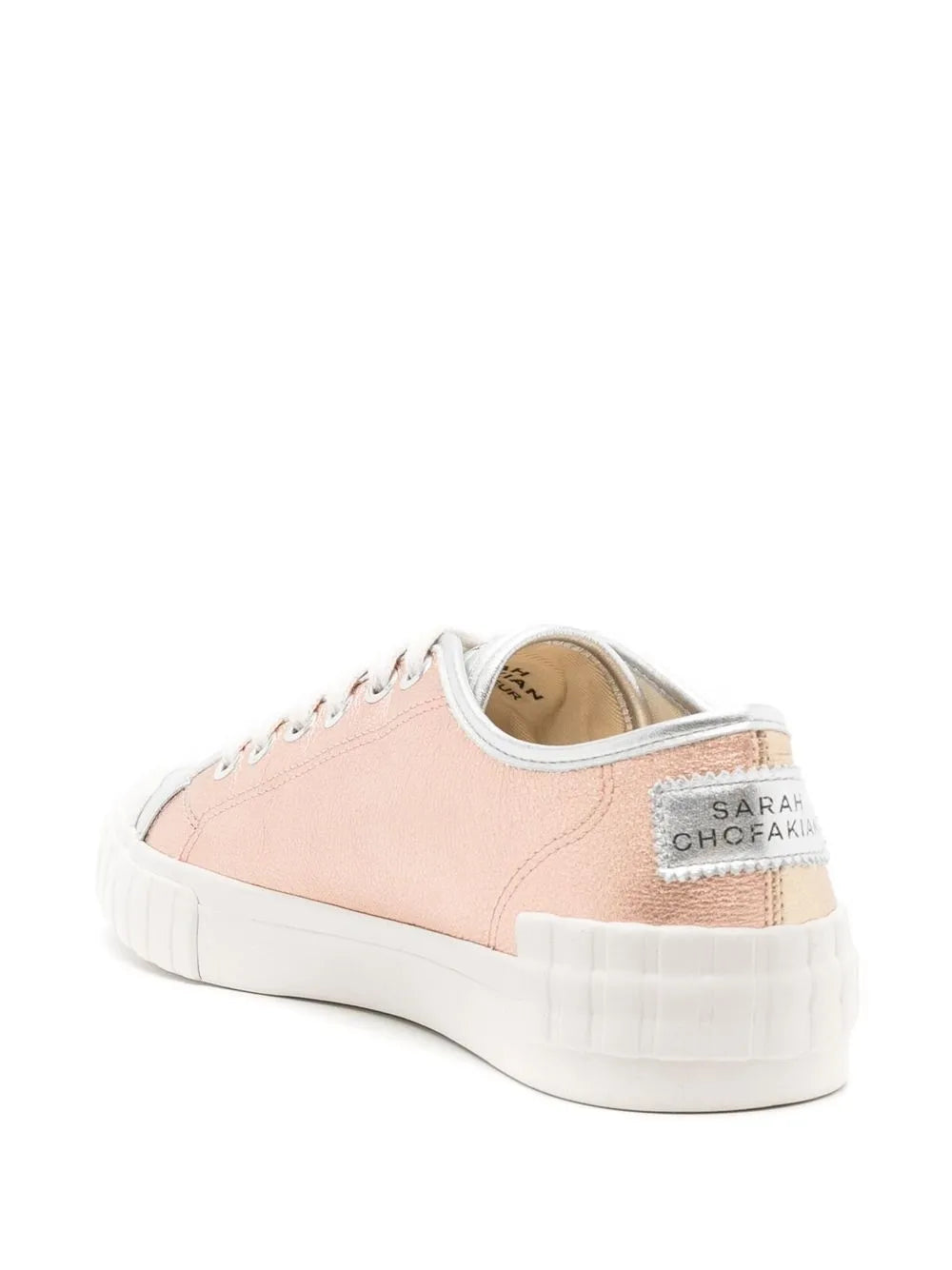 Pink metallic low-top sneaker with white sole, lace-up front, and heel logo patch
