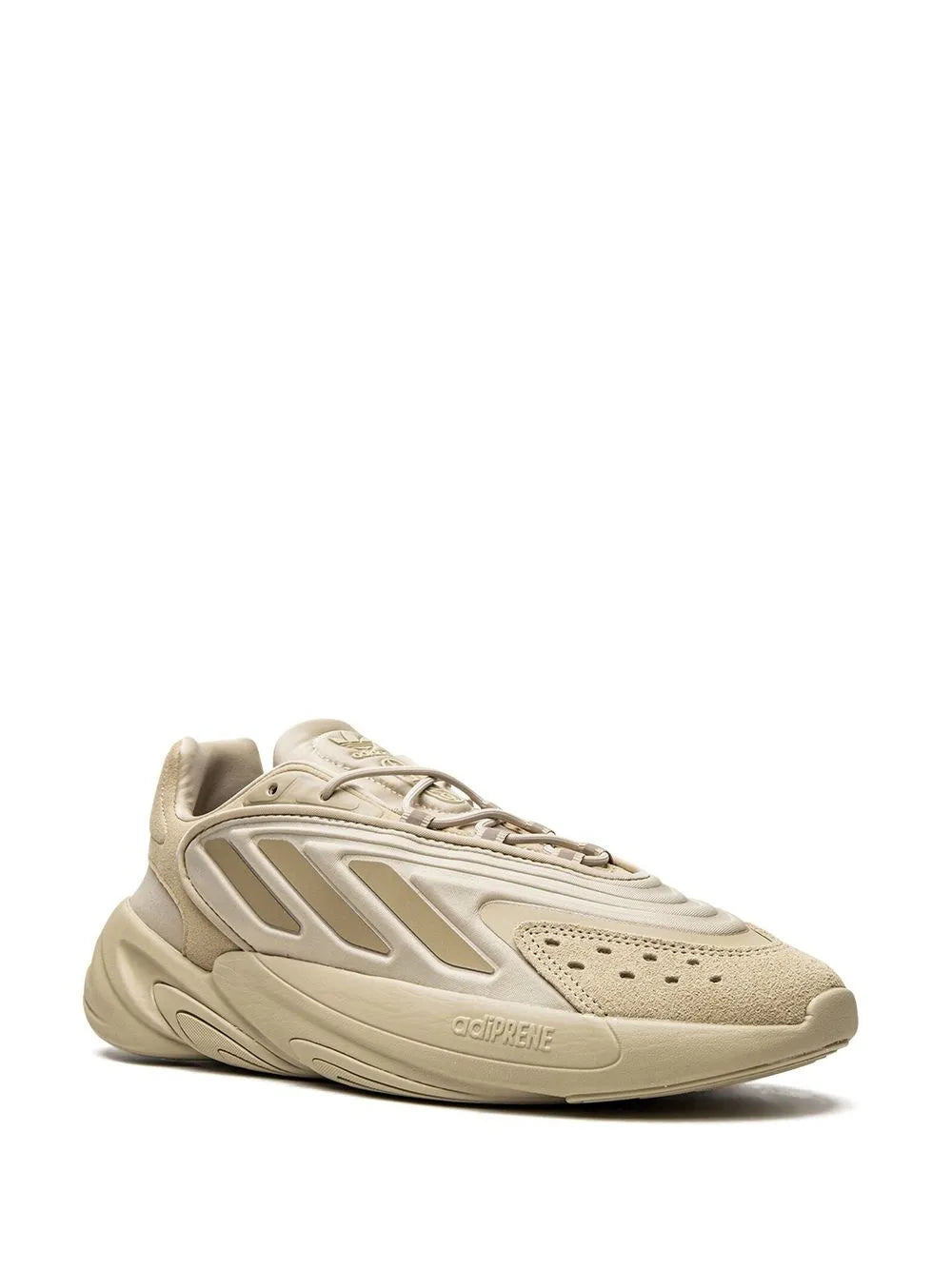 Beige adidas Ozelia low-top sneakers with perforated toe and lace-up design