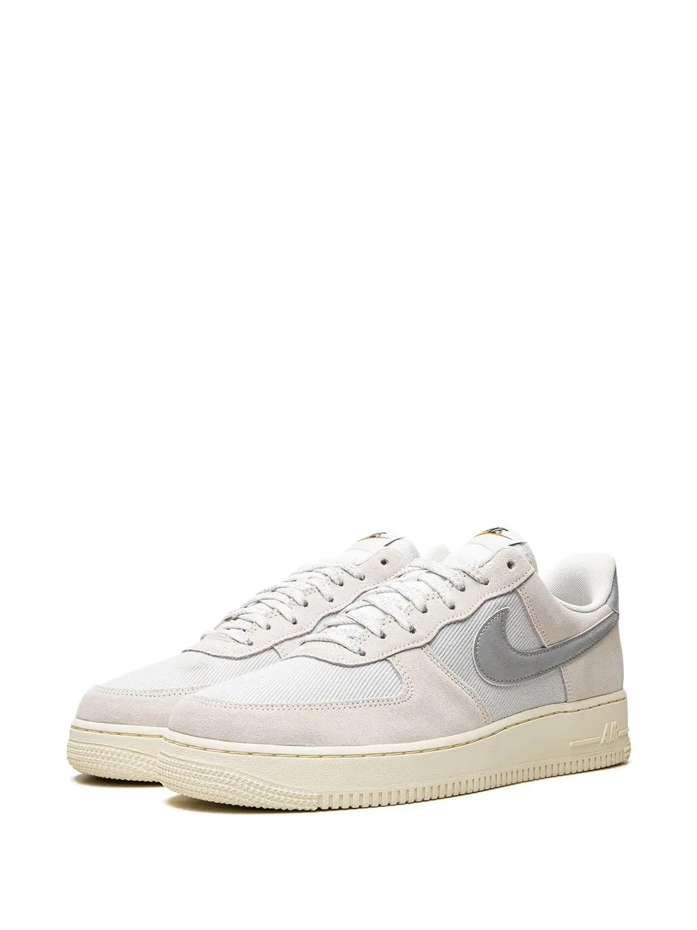 Beige leather low-top sneakers with gray swoosh and off-white sole