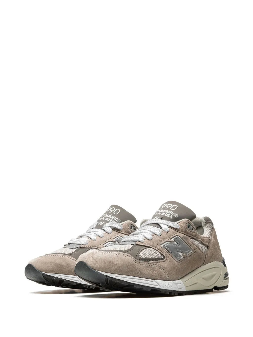 Grey suede New Balance sneakers with white midsoles and lace eyelets