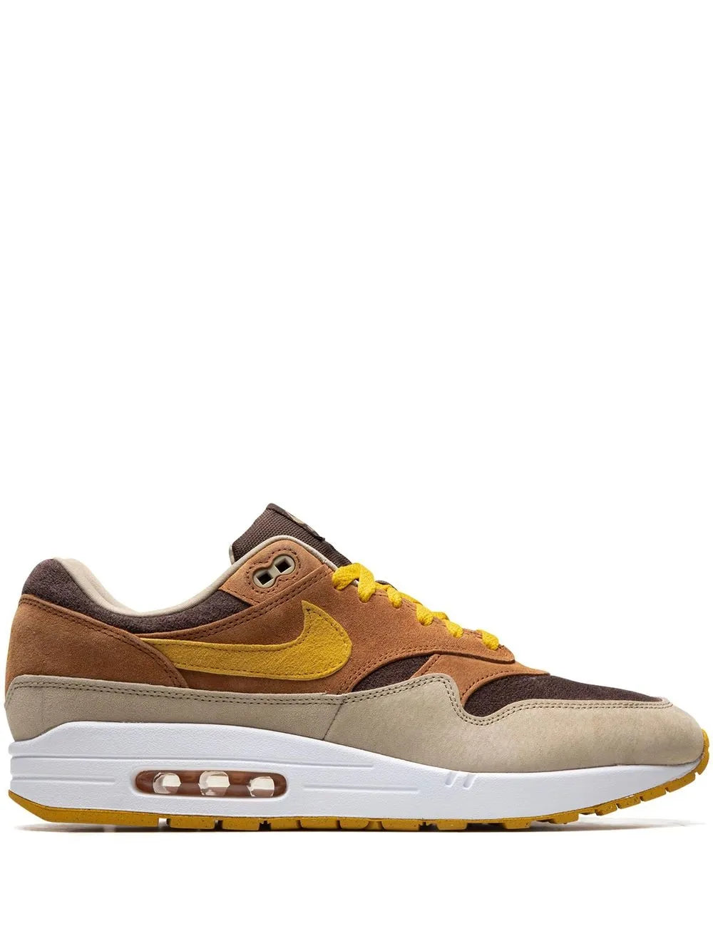 Brown Nike Air Max 1 low-top sneaker with yellow accents and visible Air unit