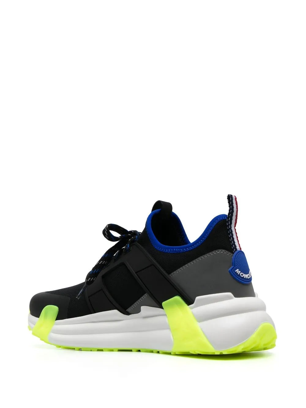 Black low-top sneakers with neon green sole accents and blue collar lining