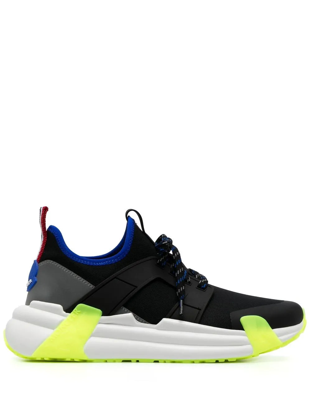 Black low-top sneakers with neon green accents and chunky white sole