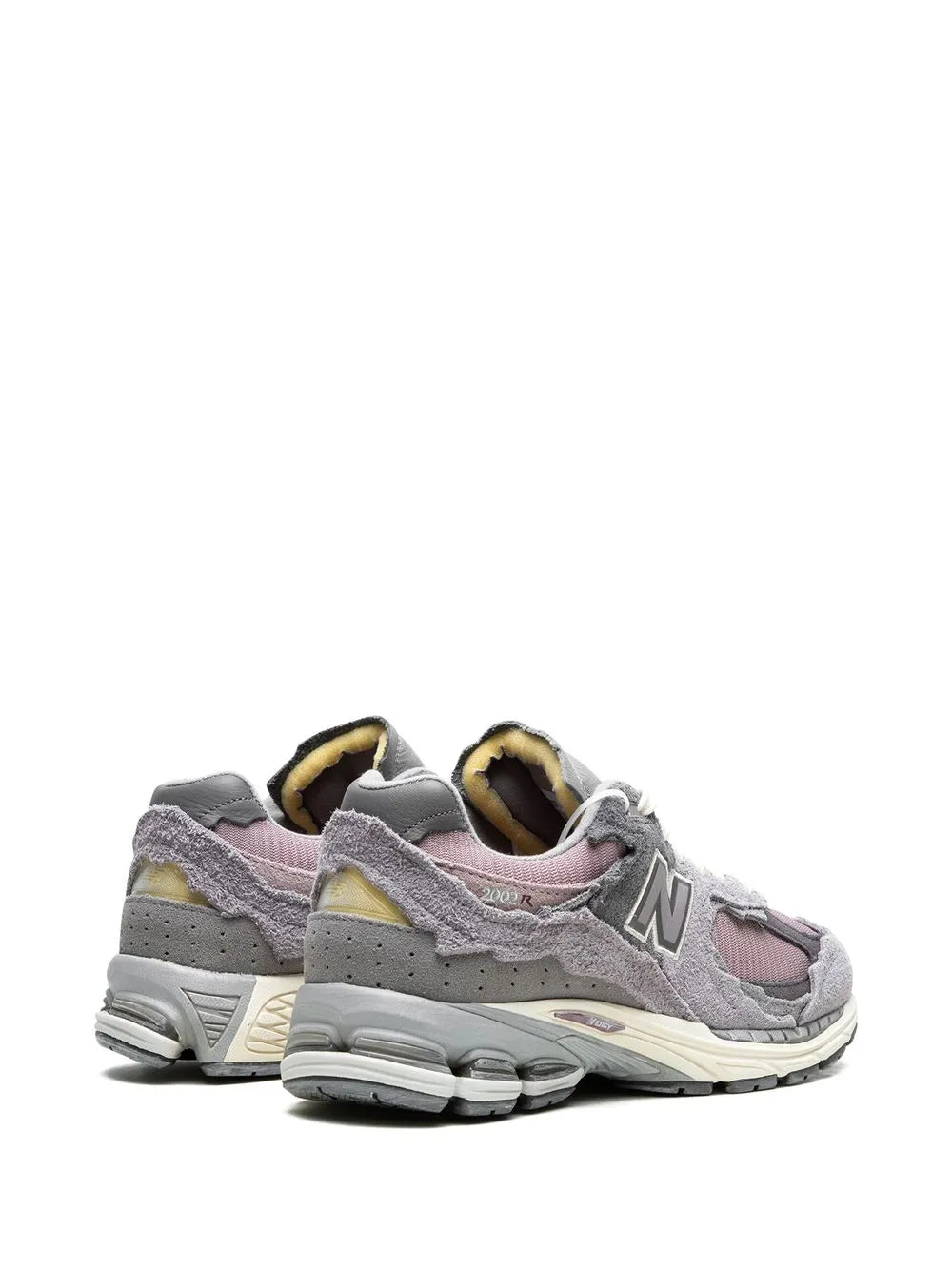 2002R sneakers: gray upper, lavender-pink accents, yellow-tan lining, heel view