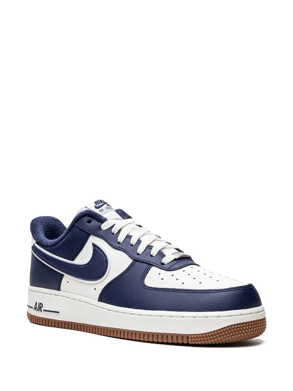 Nike low-top sneaker with navy panels, white toe, and gum sole