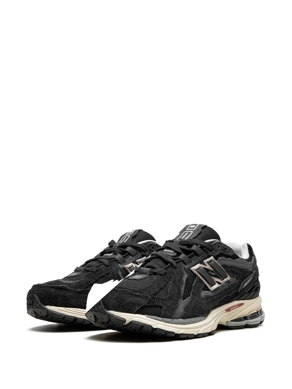 Black pair of lace-up sneakers with metallic N logo panels and beige cushioning sole