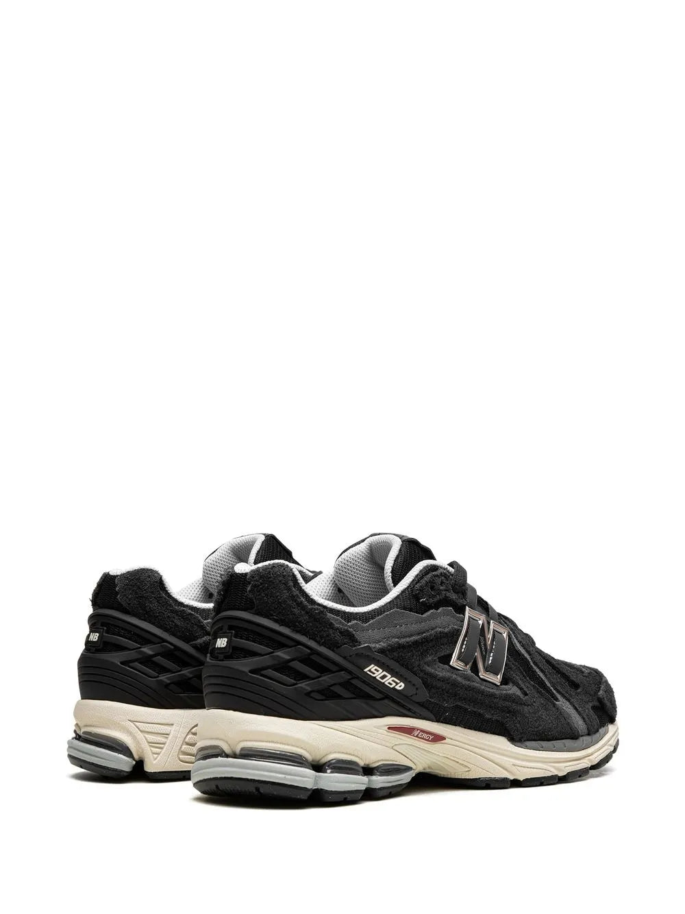 Black lace-up sneakers, rear 3/4 view with heel pull and N logo on side