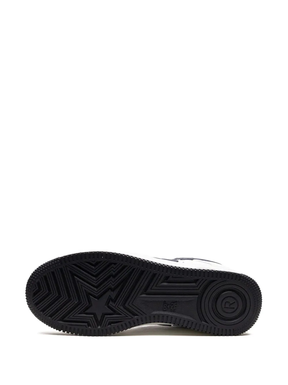 White low-top sneakers with textured black rubber outsole tread