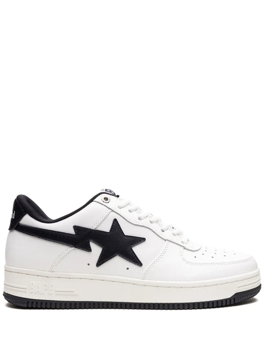 White and black low-top sneakers with large black star logo and lace-up front