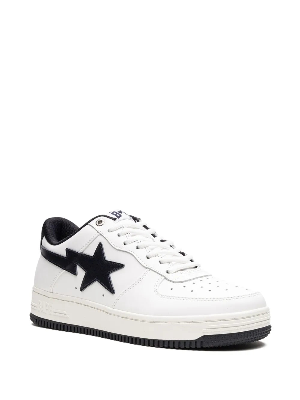 White low-top sneakers with black star side panel, black heel tab, and lace-up