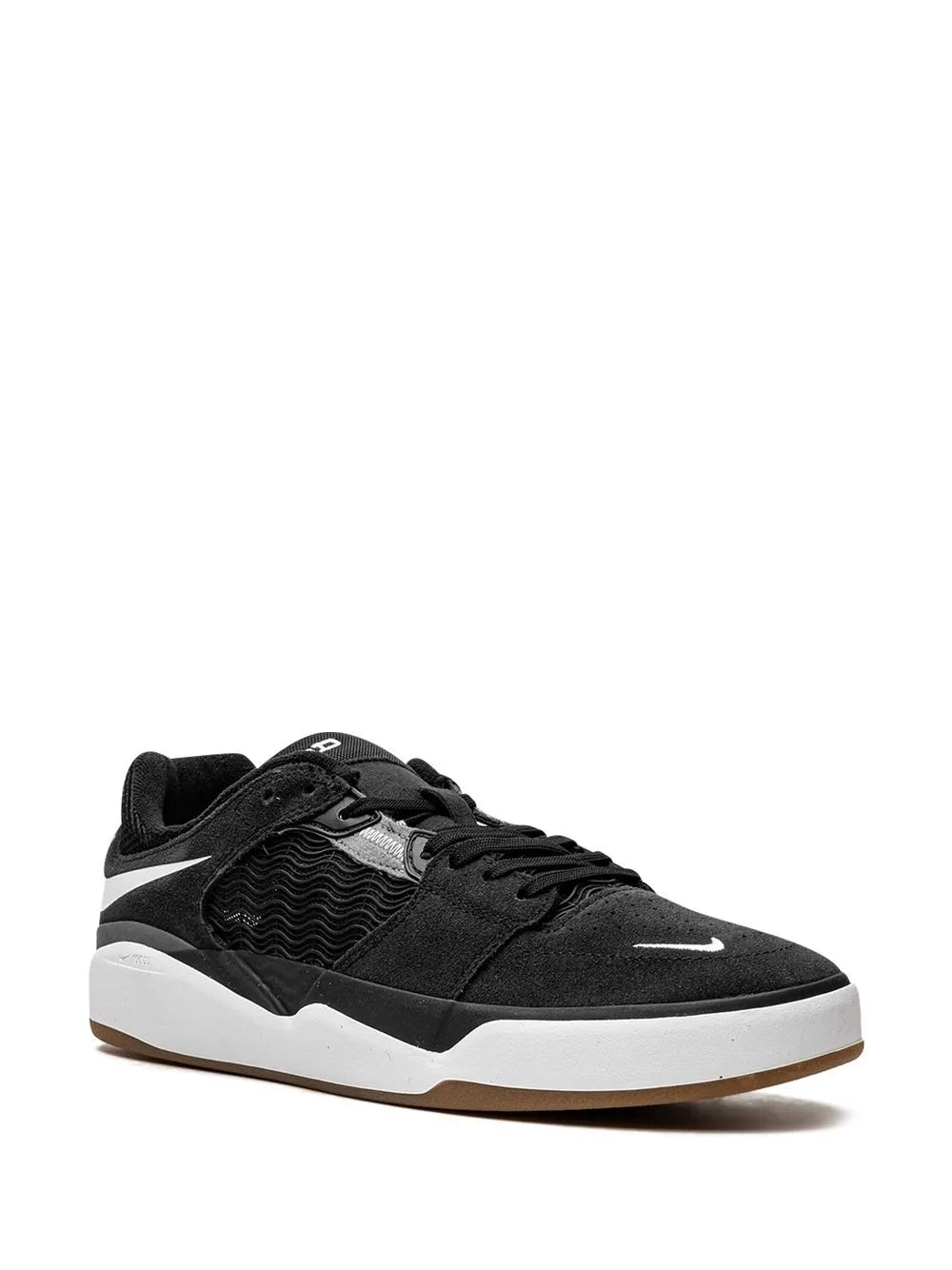Black Nike SB skate shoes, side view with white Swoosh and white midsole edge.
