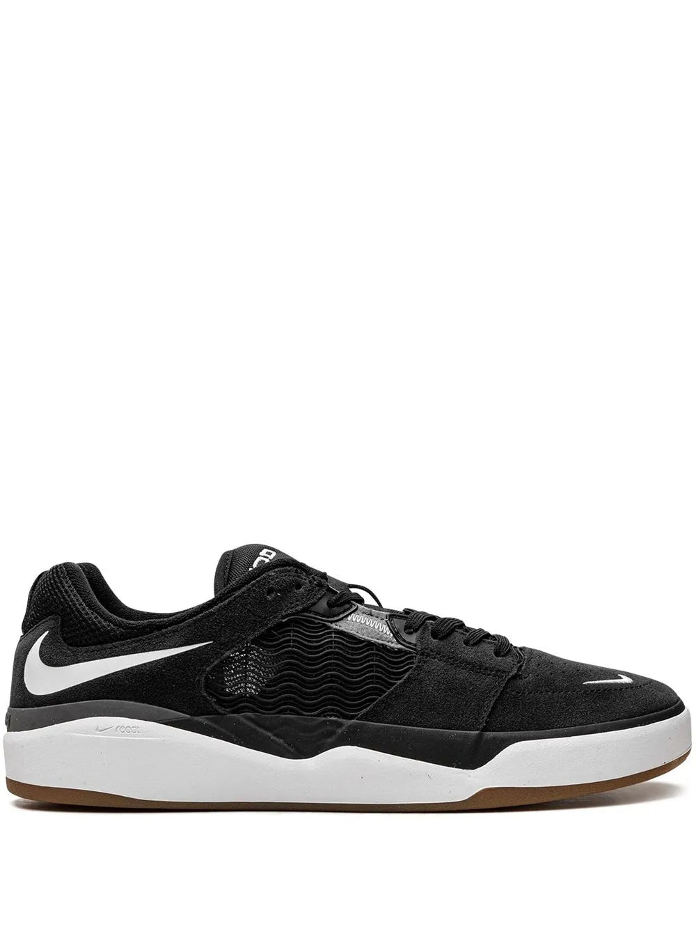 Black Nike SB skate shoes with white Swoosh and textured panels, low-top lace-up.