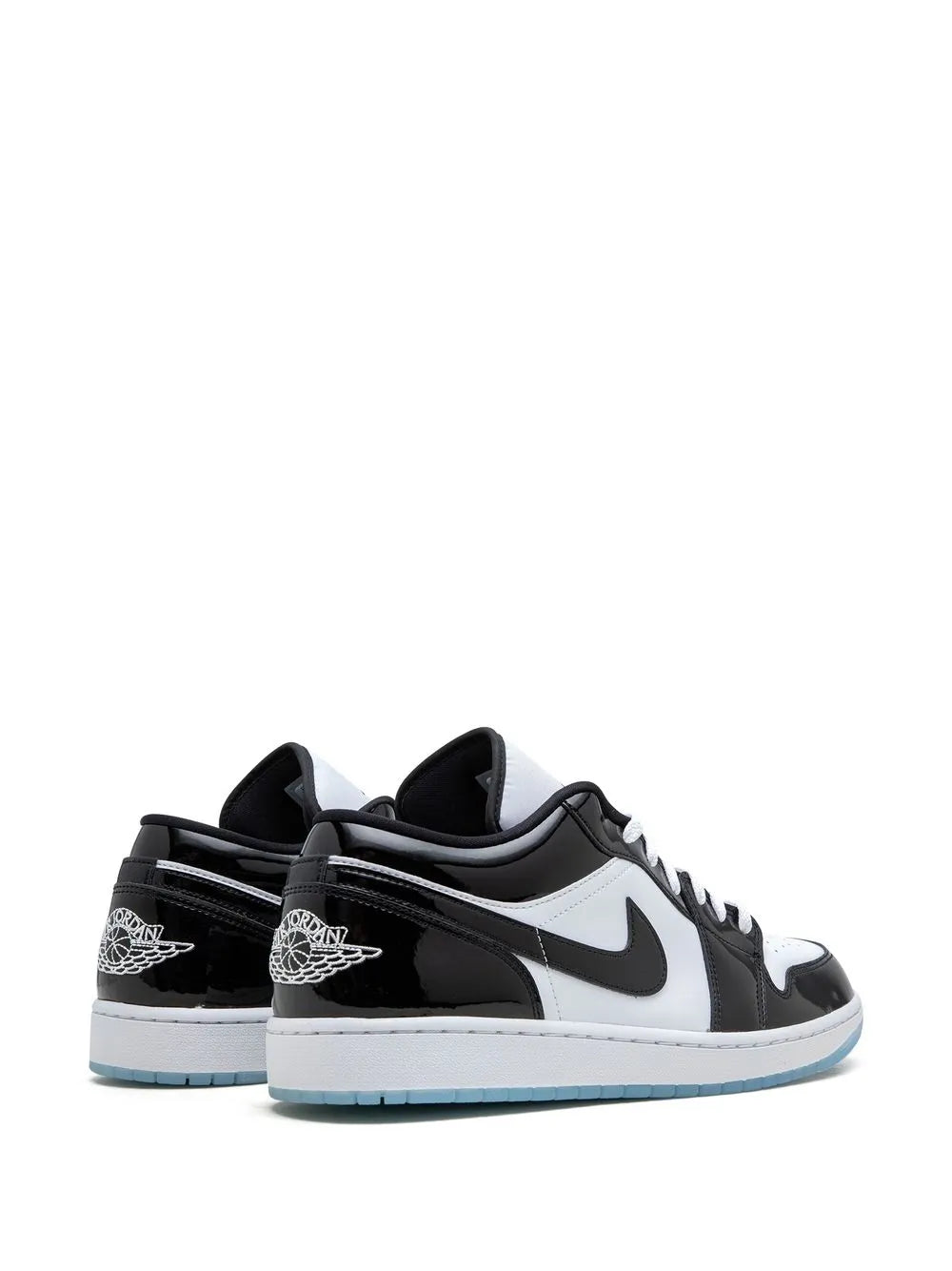 Pair of black and white low-top sneakers with Nike swoosh and blue outsole