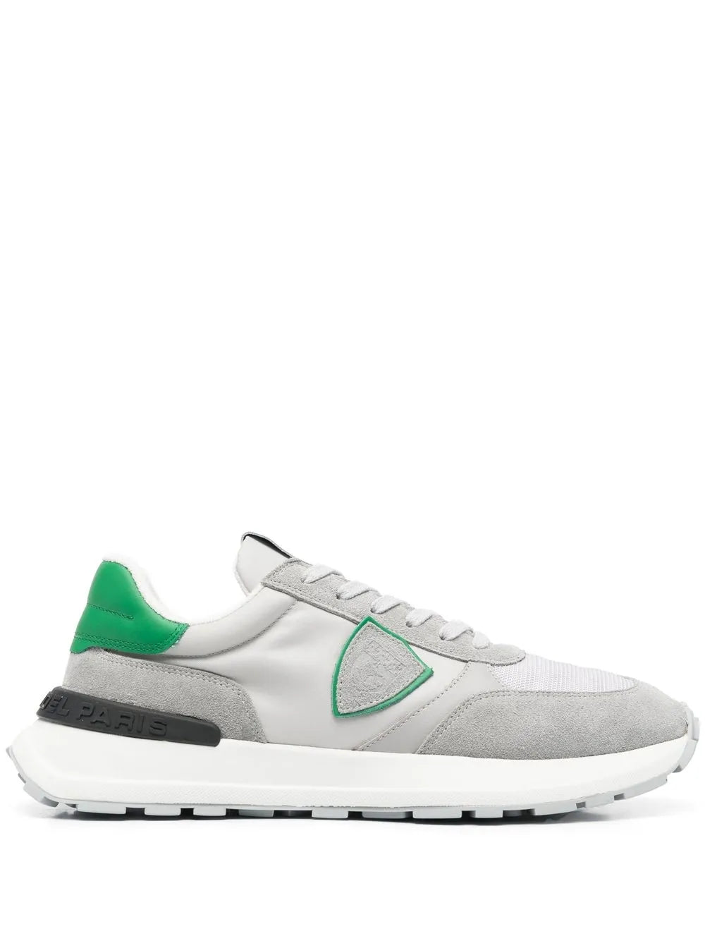 Grey low-top sneakers with green heel tab and triangular logo patch, lace-up