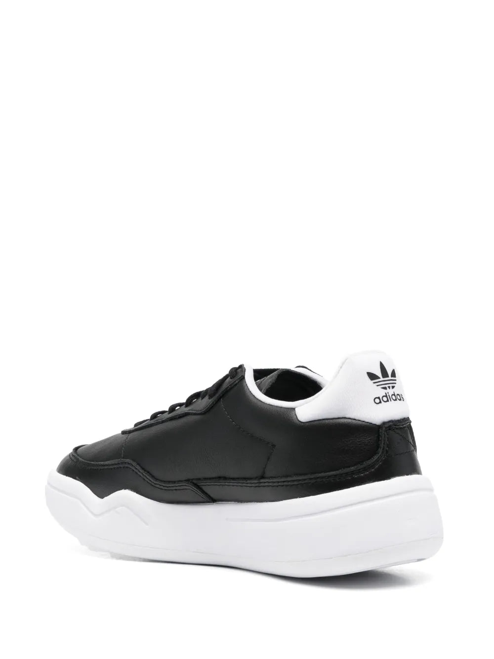 Black low-top leather sneakers with white sole and adidas heel patch