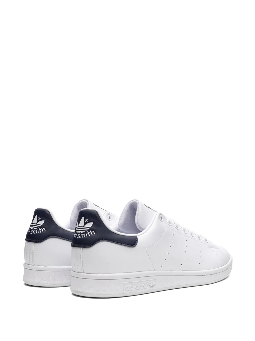 Pair of white adidas Stan Smith sneakers with navy collar lining, rear/side angle