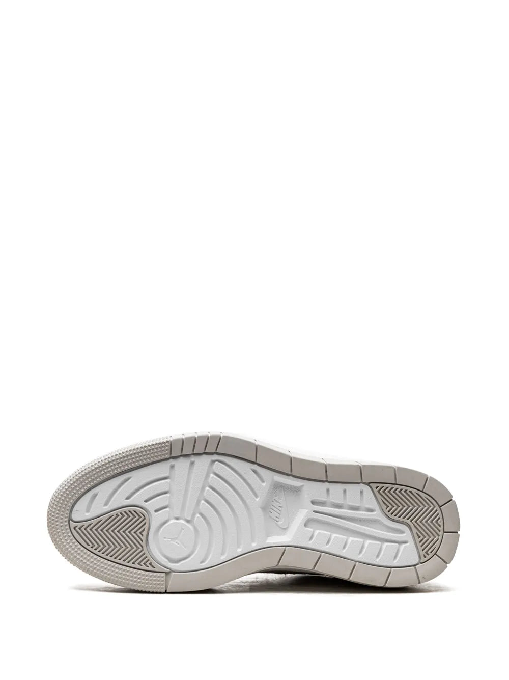 White sneaker outsole with textured tread and traction details