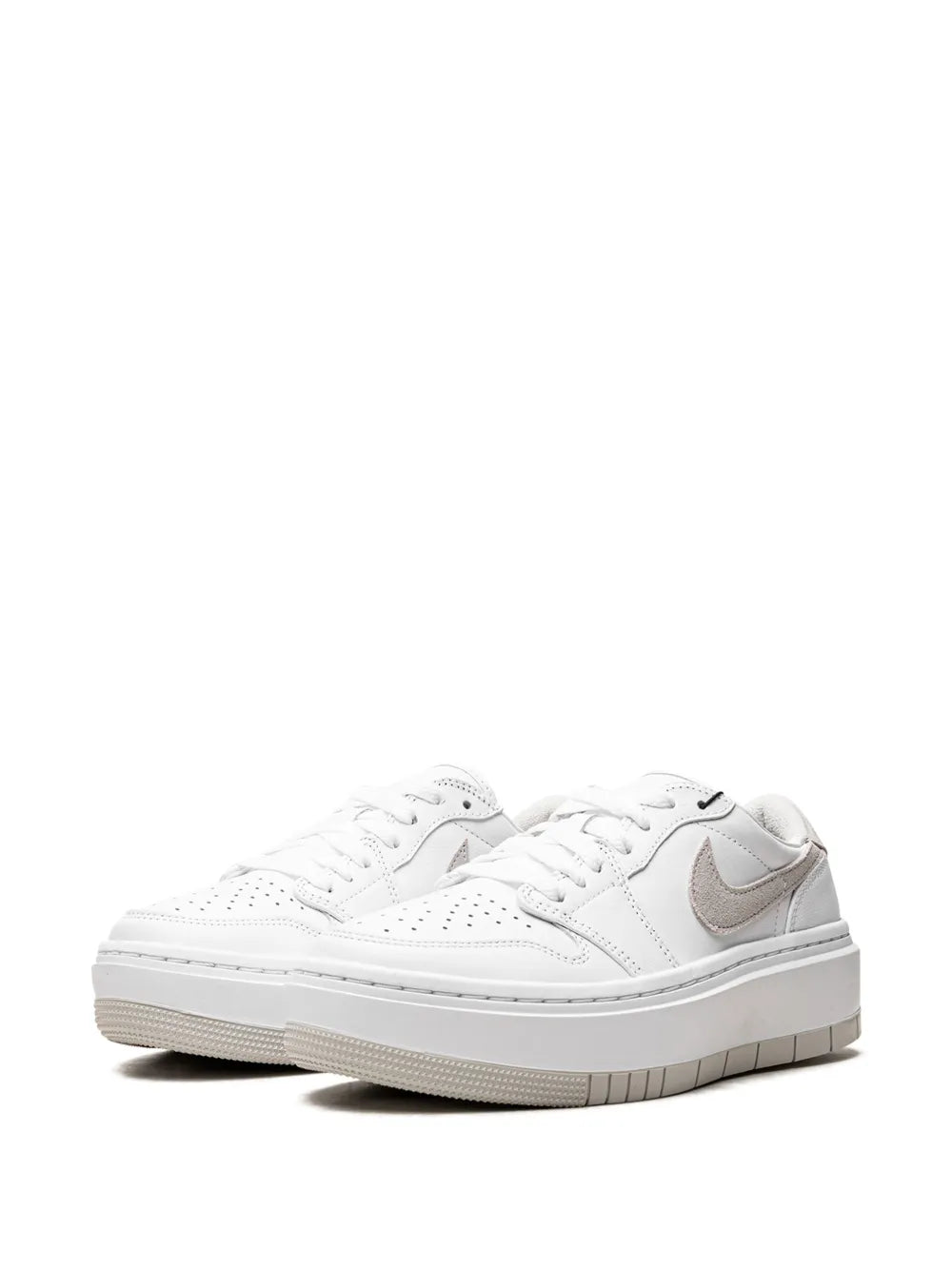 White low-top sneakers pair, lace-up design with taupe Swoosh