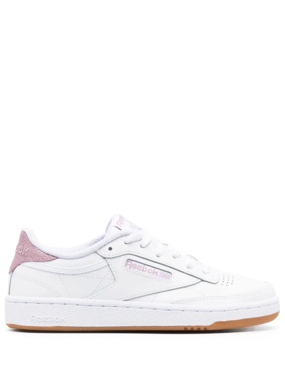 White low-top sneaker with Reebok logo, pink accents, and tan gum sole